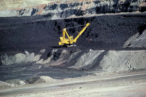 Large mining machine excavating coal in an open-pit mine.