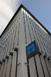 Modern building with a logo under a clear sky.
