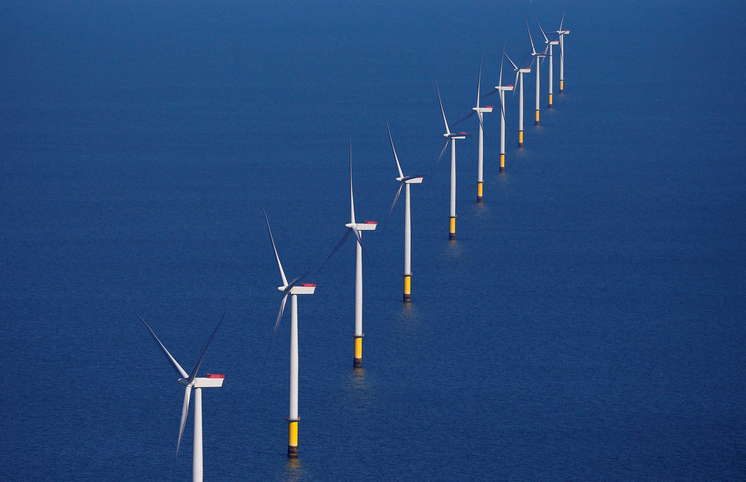 Wind turbines generating power across the ocean.