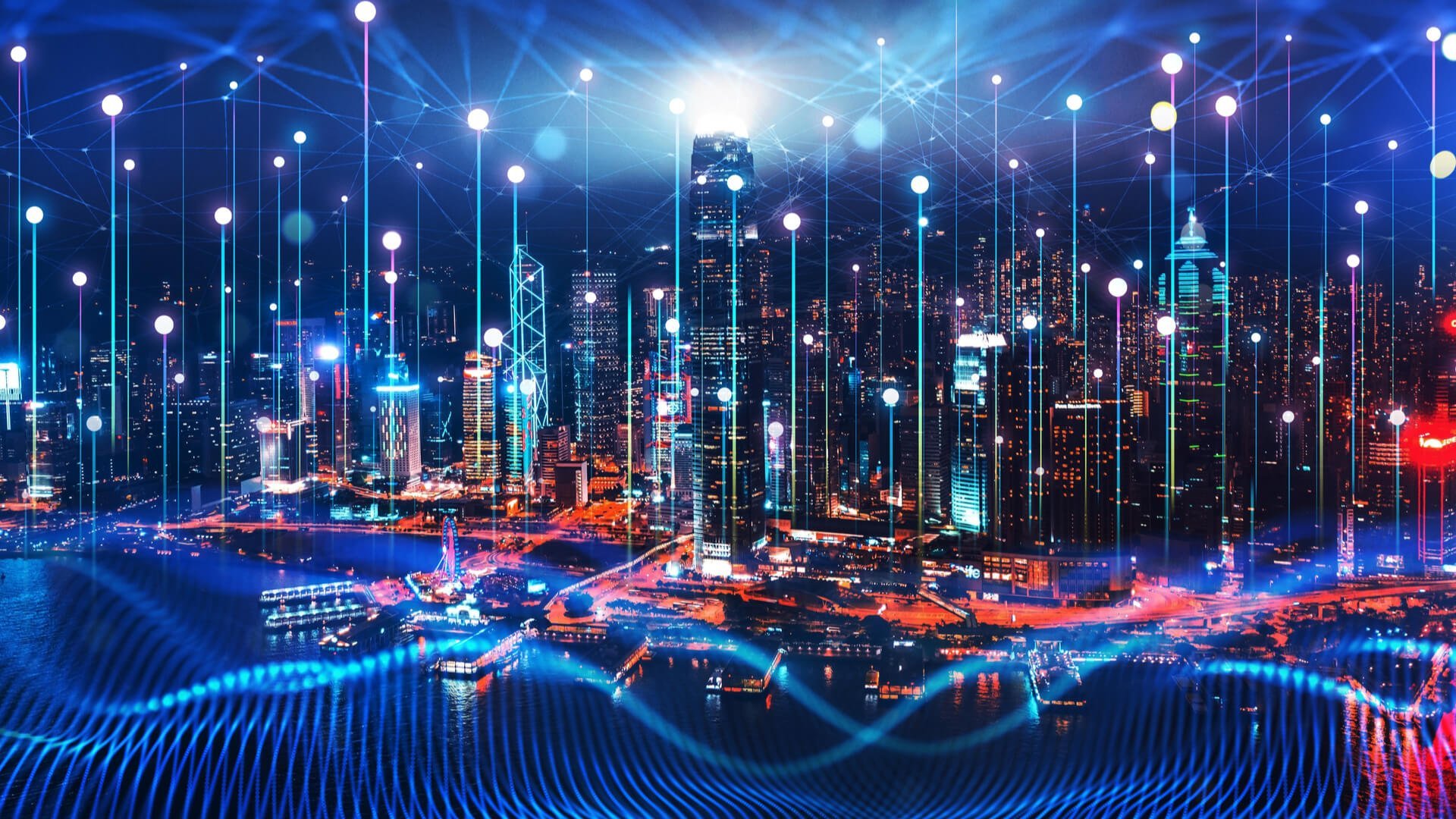 Nighttime cityscape with glowing network effect over water.