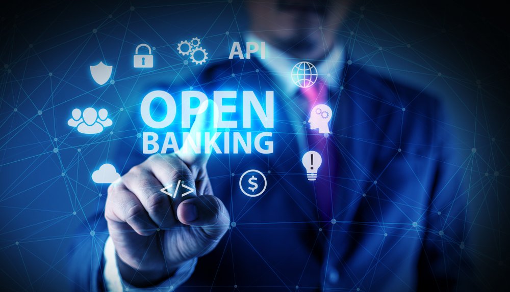 Hand pointing at "OPEN BANKING" on a digital interface.