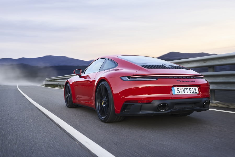 Red Porsche on a winding mountain road.