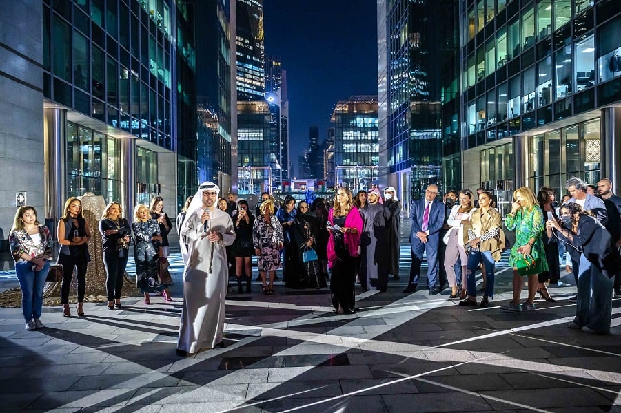 Emirati man speaking into a microphone at an outdoor event.