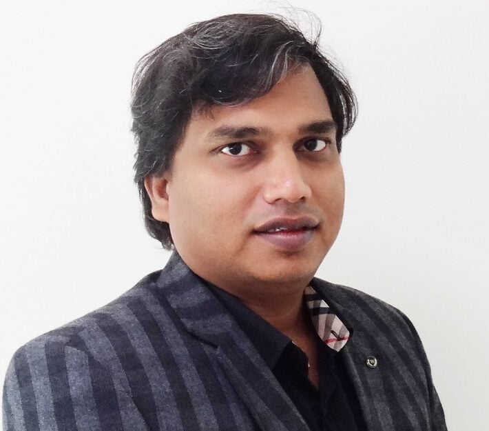 Man in a gray pinstripe jacket.