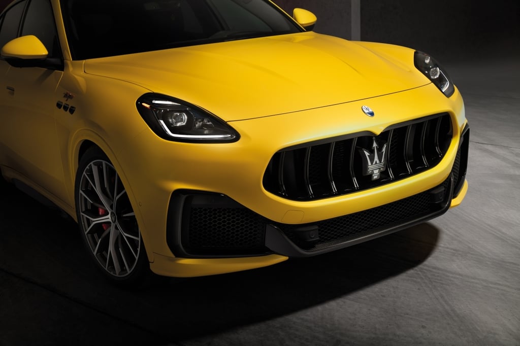 Yellow Maserati Grecale Trofeo in a dark garage.
