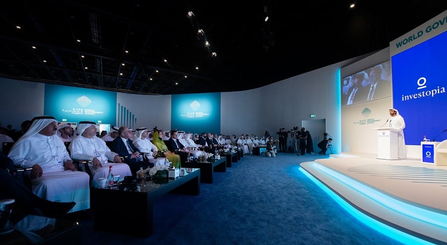 Man speaks at podium at World Government Summit, audience seated.