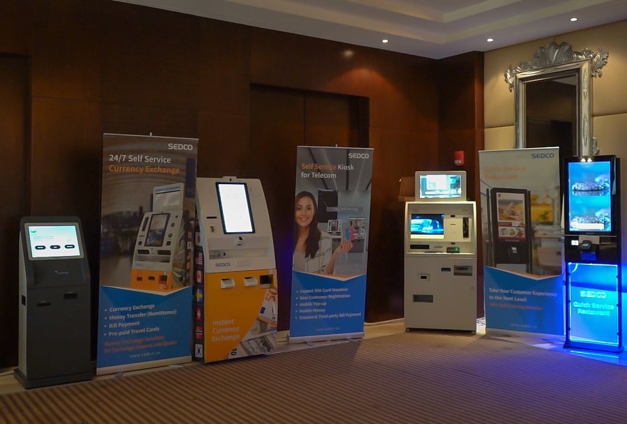 Self-service kiosks for various services in a hotel lobby.