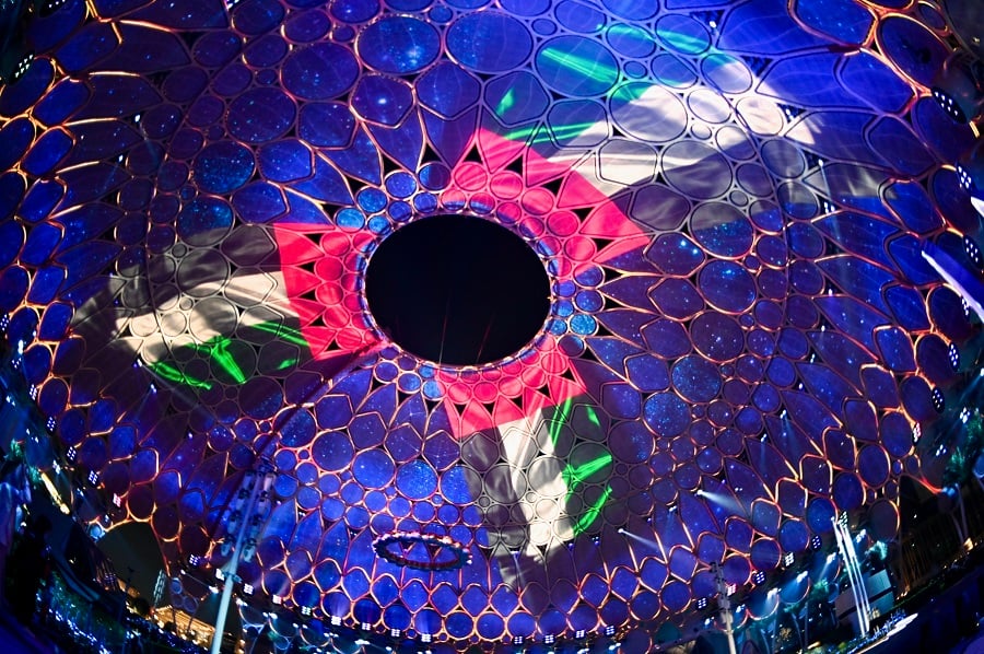 Illuminated dome with projected flag and laser lights.