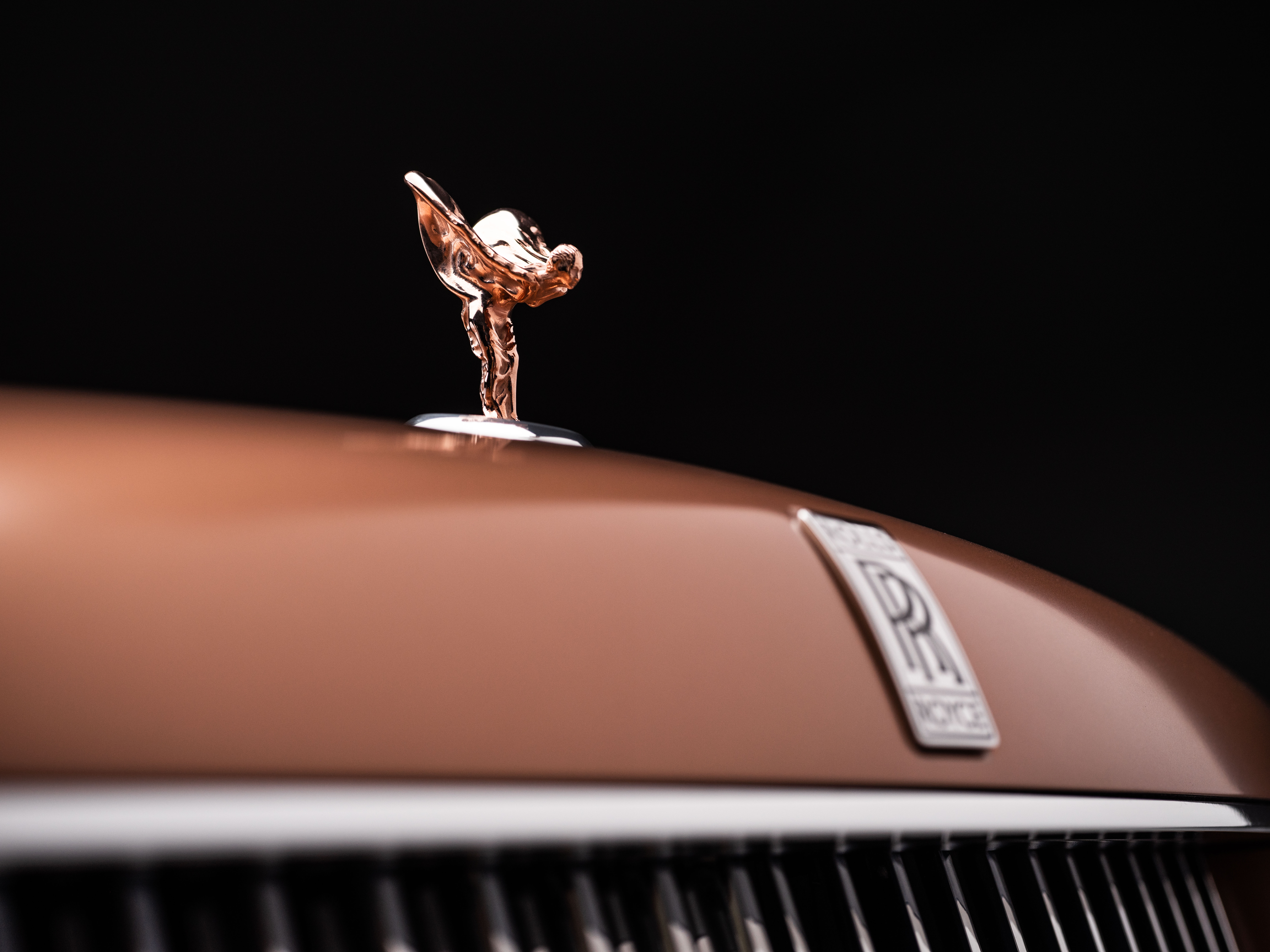 Rose gold Spirit of Ecstasy on a Rolls-Royce hood ornament.