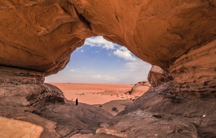 Rock formation framing a desert vista.