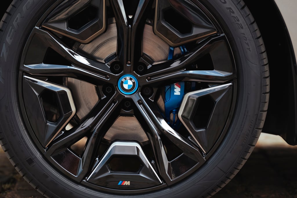 Black BMW alloy wheel with blue M brake caliper.