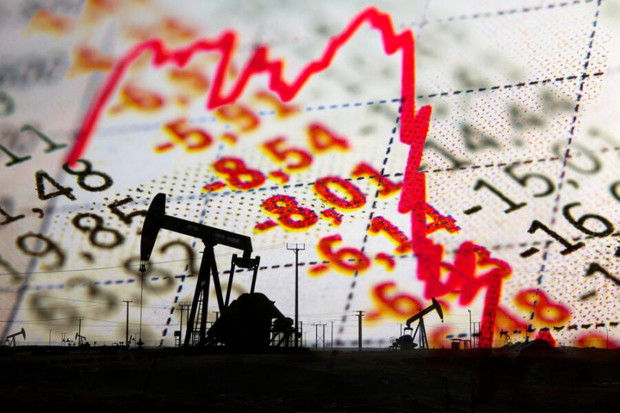 Oil pumps silhouetted against a falling stock market graph.