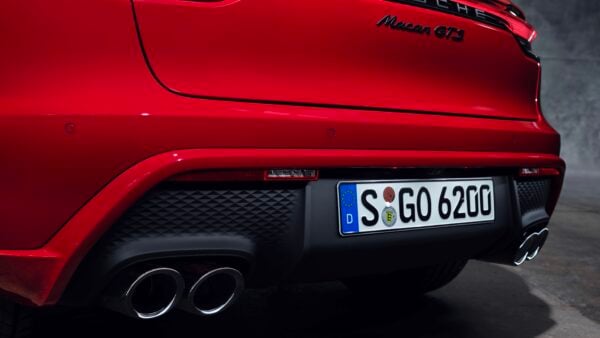 Red Porsche Macan GTS in garage.