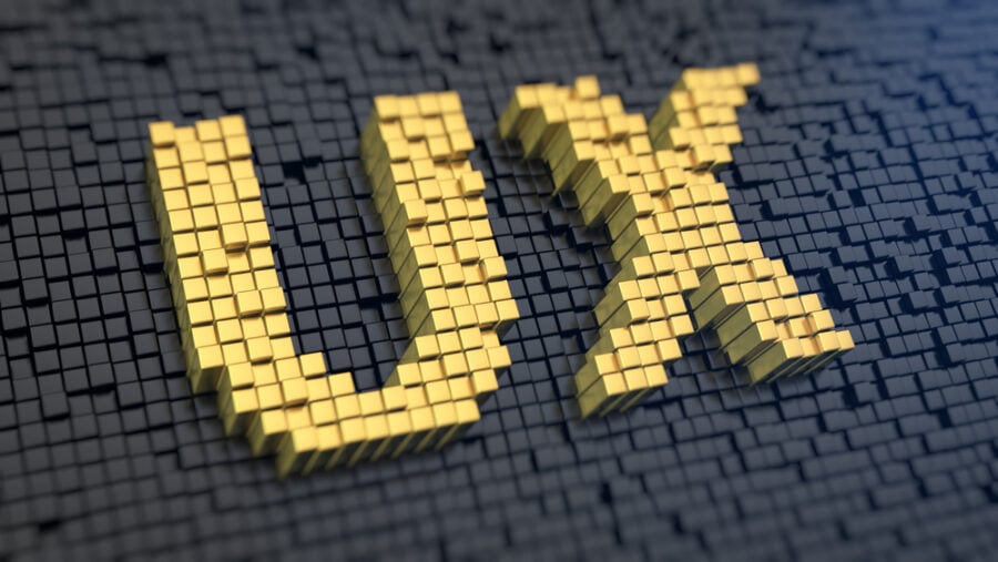 Gold cubes forming "UX" on a dark background.