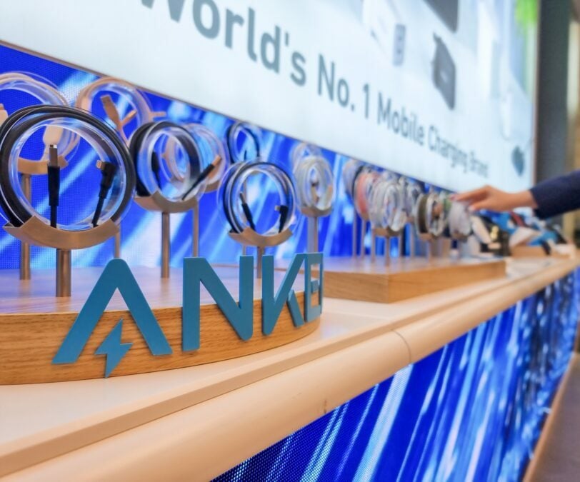 Coiled charging cables with Anke's logo in a retail setting.