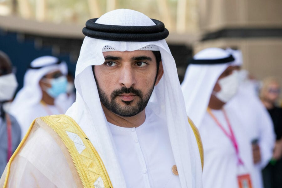 Man in white thawb and ghutra in a public area.