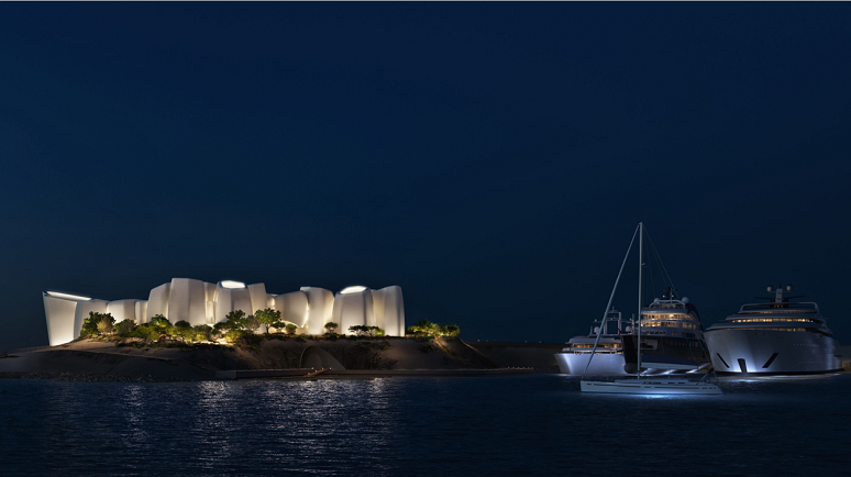 Illuminated building on an island with yachts nearby.