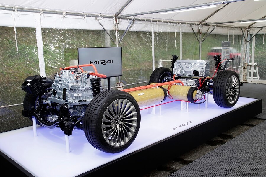 Mirai fuel cell vehicle's chassis displayed under a tent.