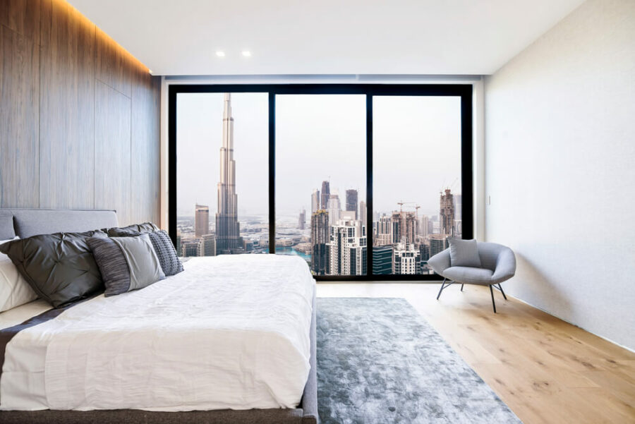 Bed in a modern bedroom with a view of the Burj Khalifa.