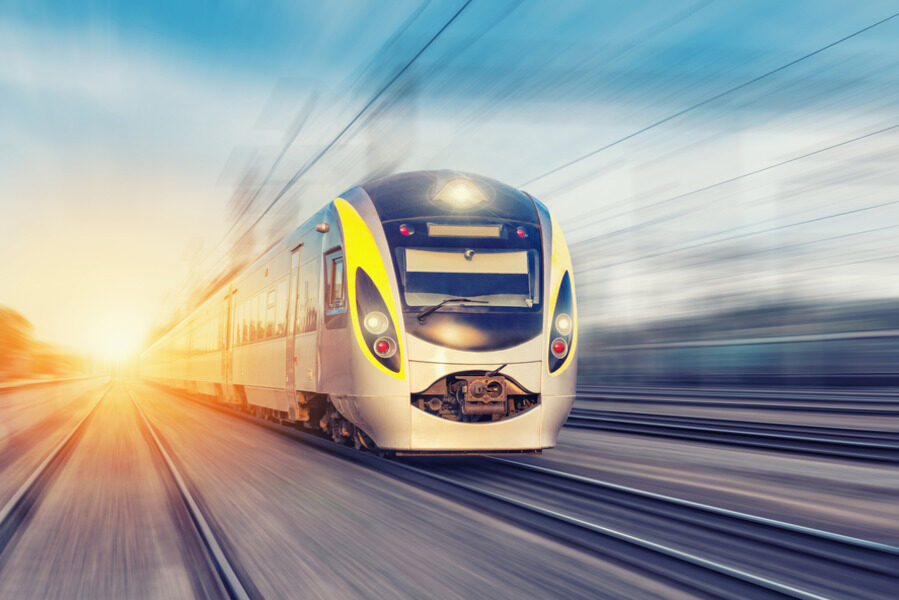 High-speed train on railway at sunset.
