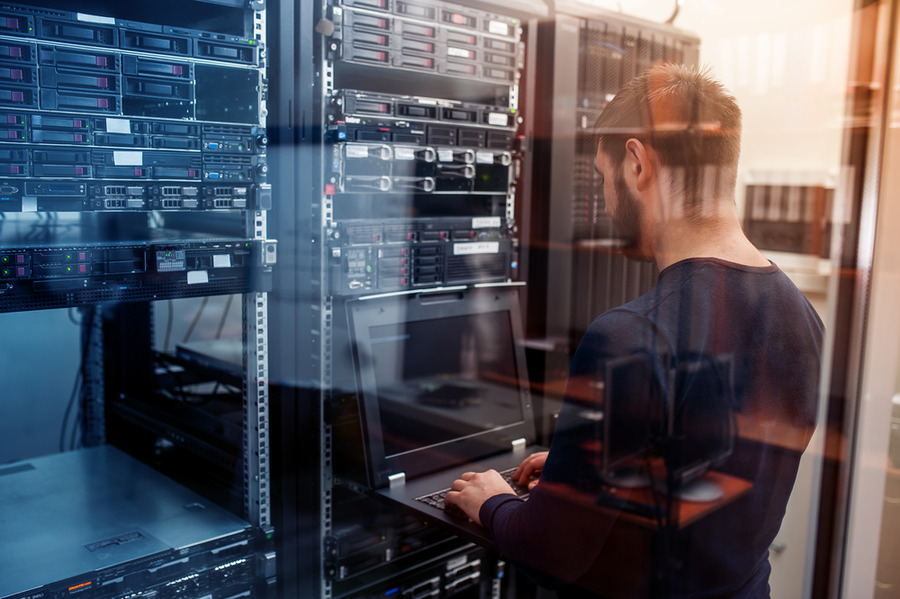 Technician managing server racks.