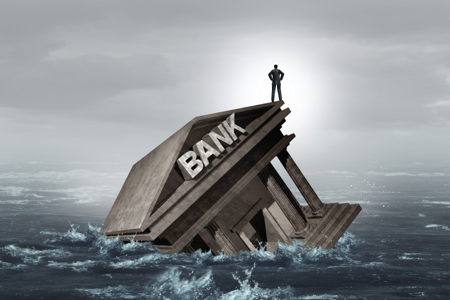 Stone bank building sinking in stormy water, businessman watching.