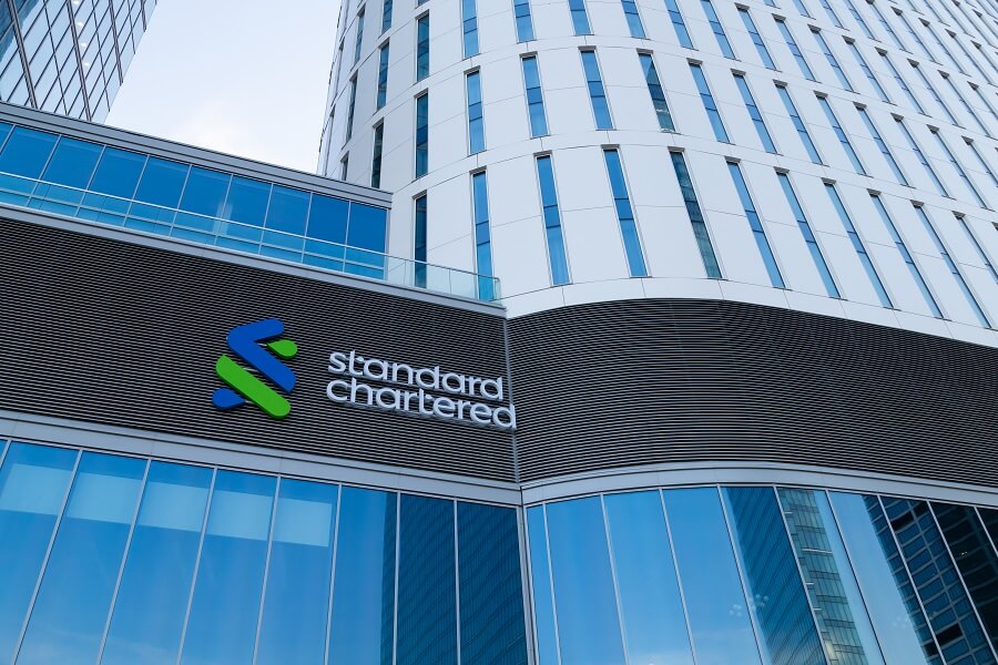 Standard Chartered logo on a modern building.
