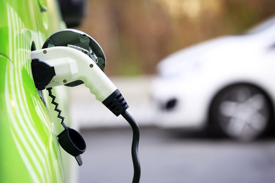 Electric car charging in an outdoor setting.