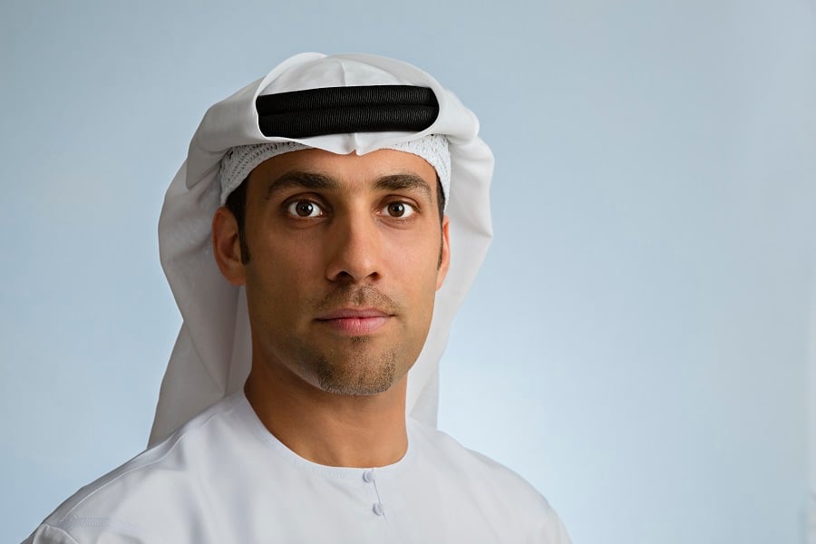 Man in traditional Arab attire looking directly at the camera.