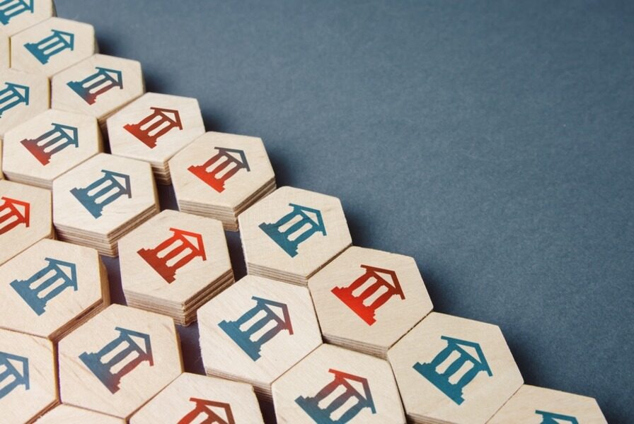 Hexagonal wooden tiles with red and blue temple icons on a dark surface.