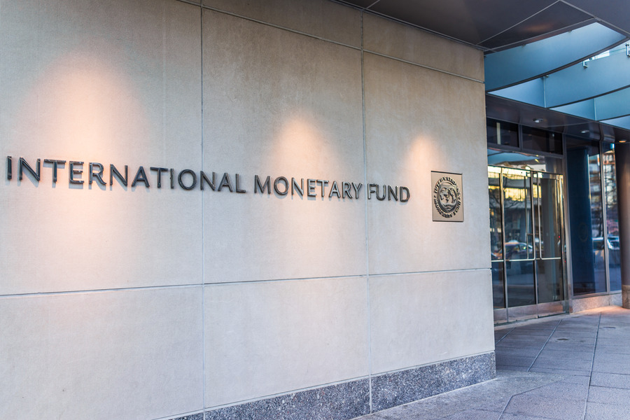 IMF building exterior with raised lettering and emblem.