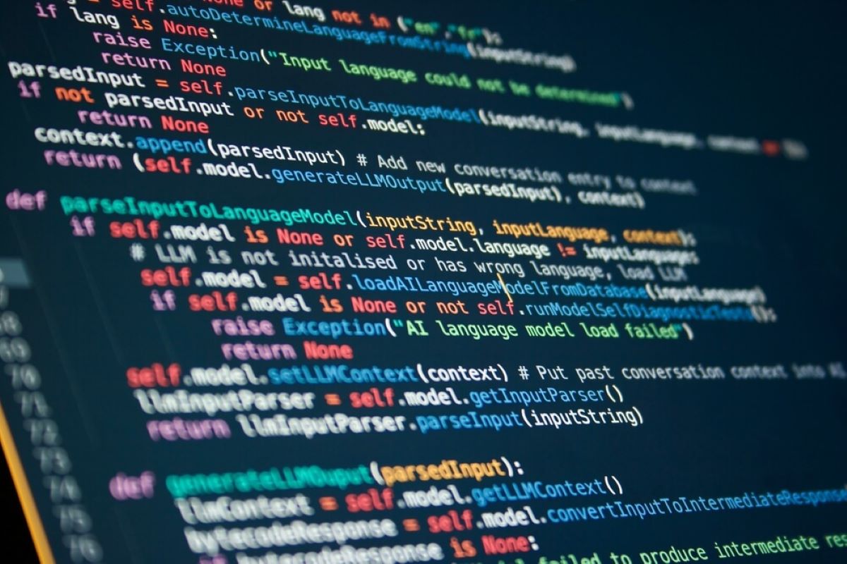 Program code executing on a screen in a dark room.