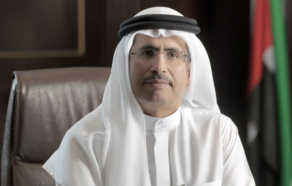 Man in white thawb in an office setting.