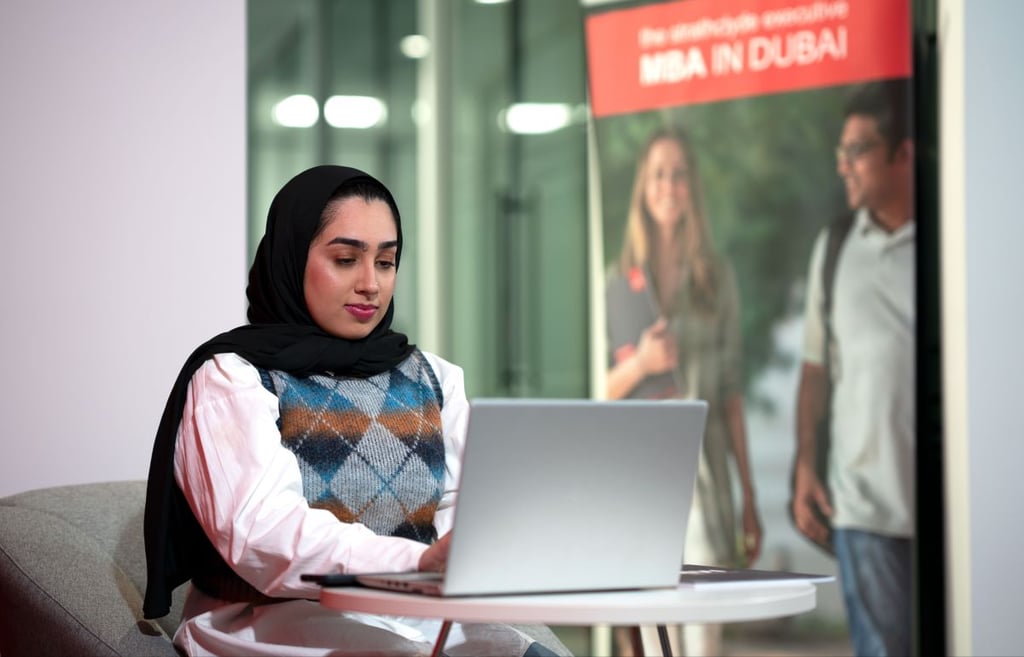 Woman in hijab using a laptop, 