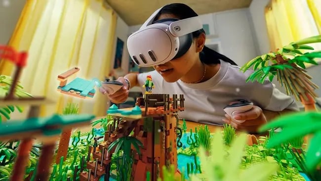 Girl in VR headset interacting with a Lego-like virtual island.