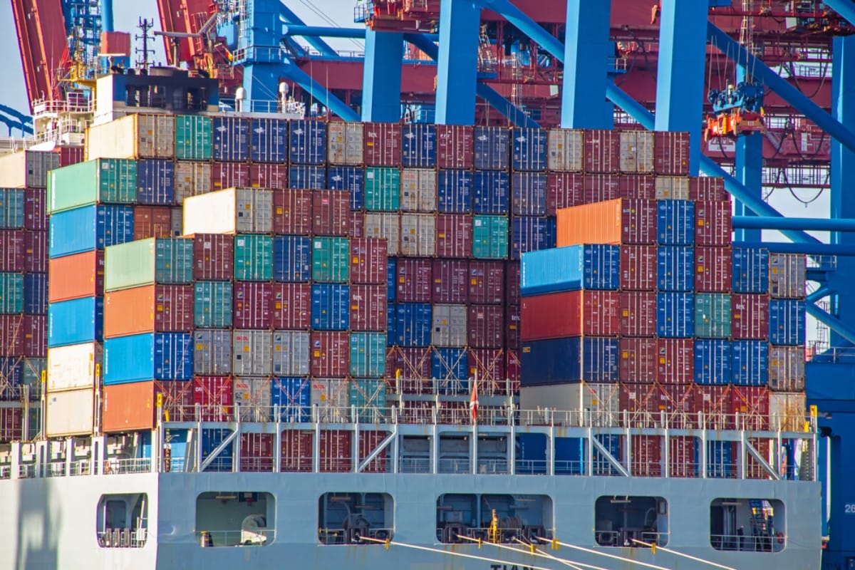 Cargo ship with colorful containers at port.