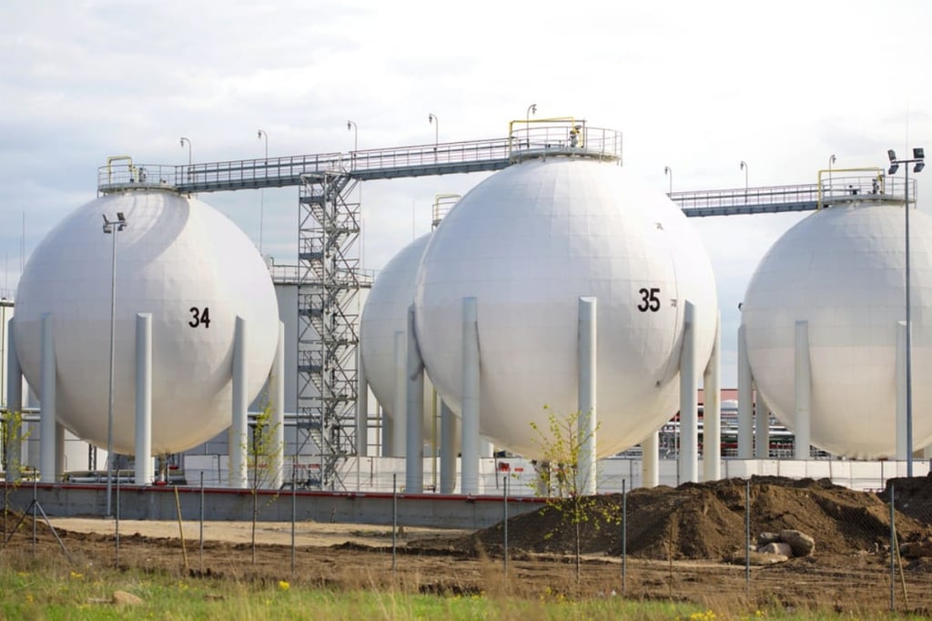 Large gas storage tanks in industrial setting.