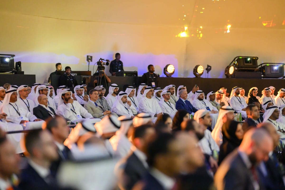 A group of men in white robes at a formal event.