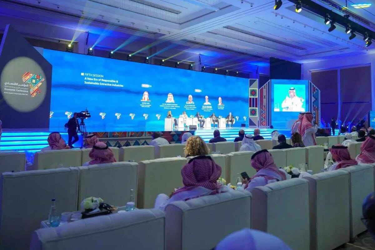 Audience watching a panel discussion at an economic conference.