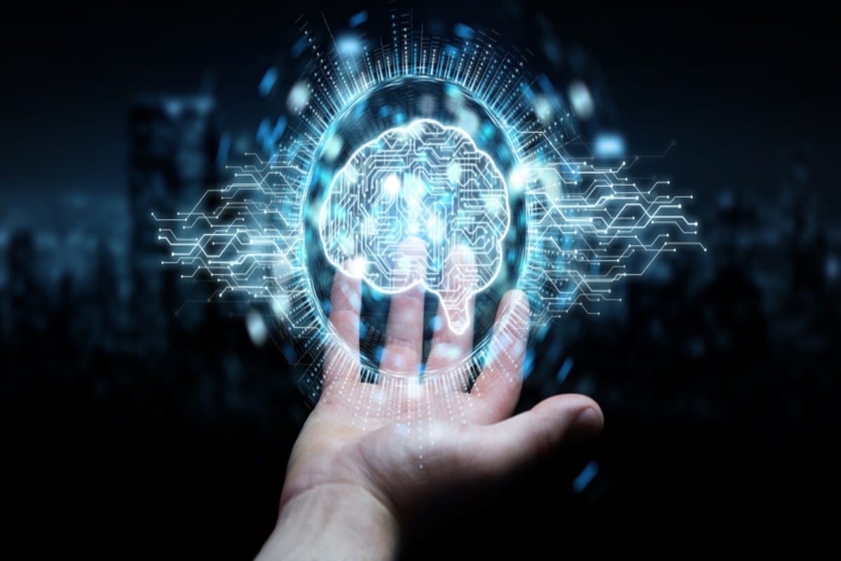 Hand holding a glowing circuit-board brain in a digital sphere.