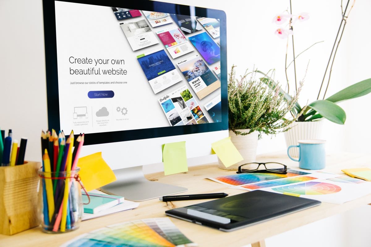 Computer screen shows website templates in a designer’s workspace.