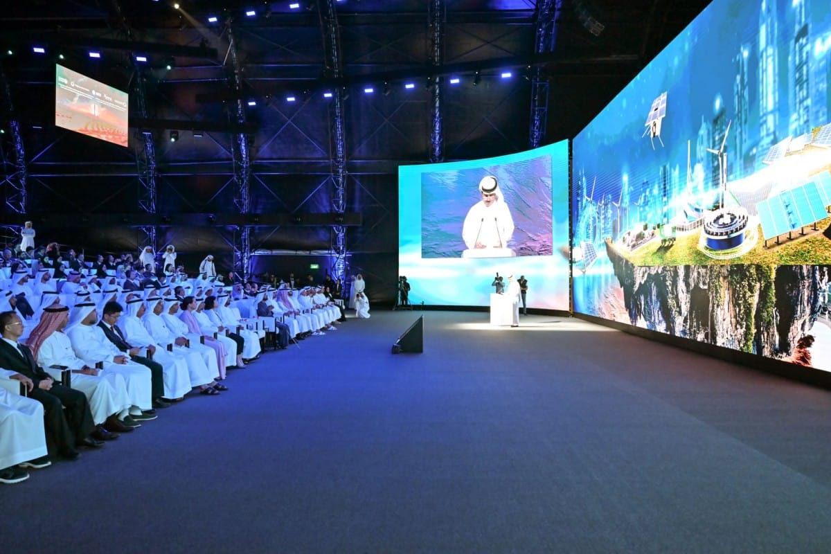 Audience watching a speaker at a tech-focused event.