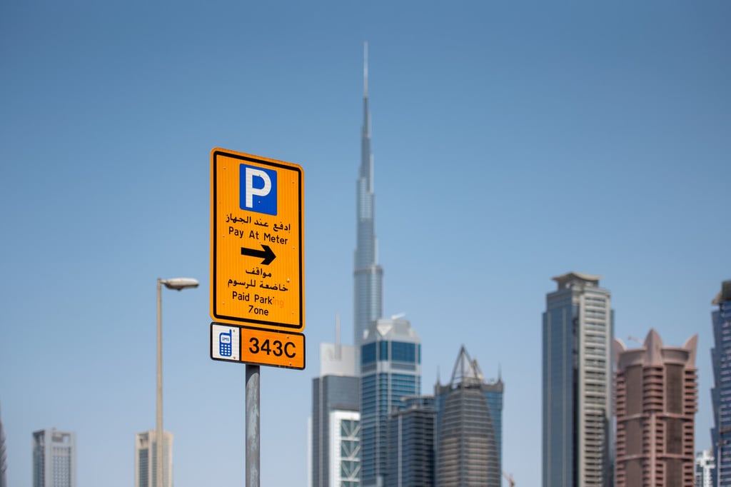 An RTA parking board with the Burj Khalifa in the background, in Dubai.