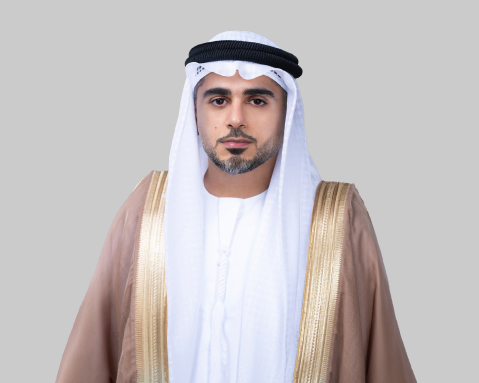 Man in kandura and ghutra posing against a plain background.