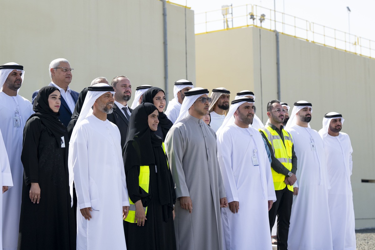 Emirati group at industrial building outdoors.