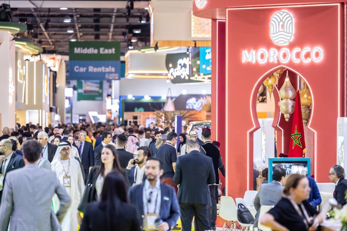 Large crowd at a convention center with a Morocco booth.
