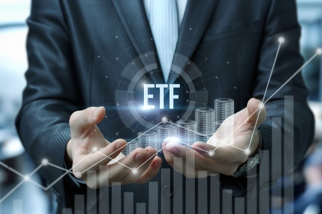 a man in a blue suit holding a graphical representation showing market charts and ETF