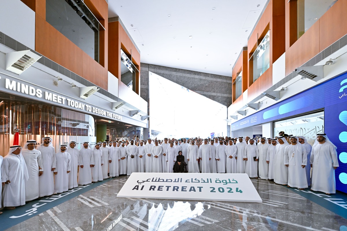Group photo at AI Retreat 2024 in a modern hall.