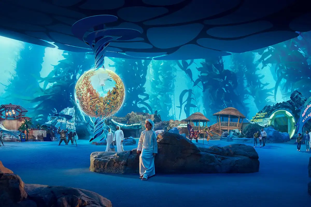 Young man observing a golden sphere in an underwater environment.