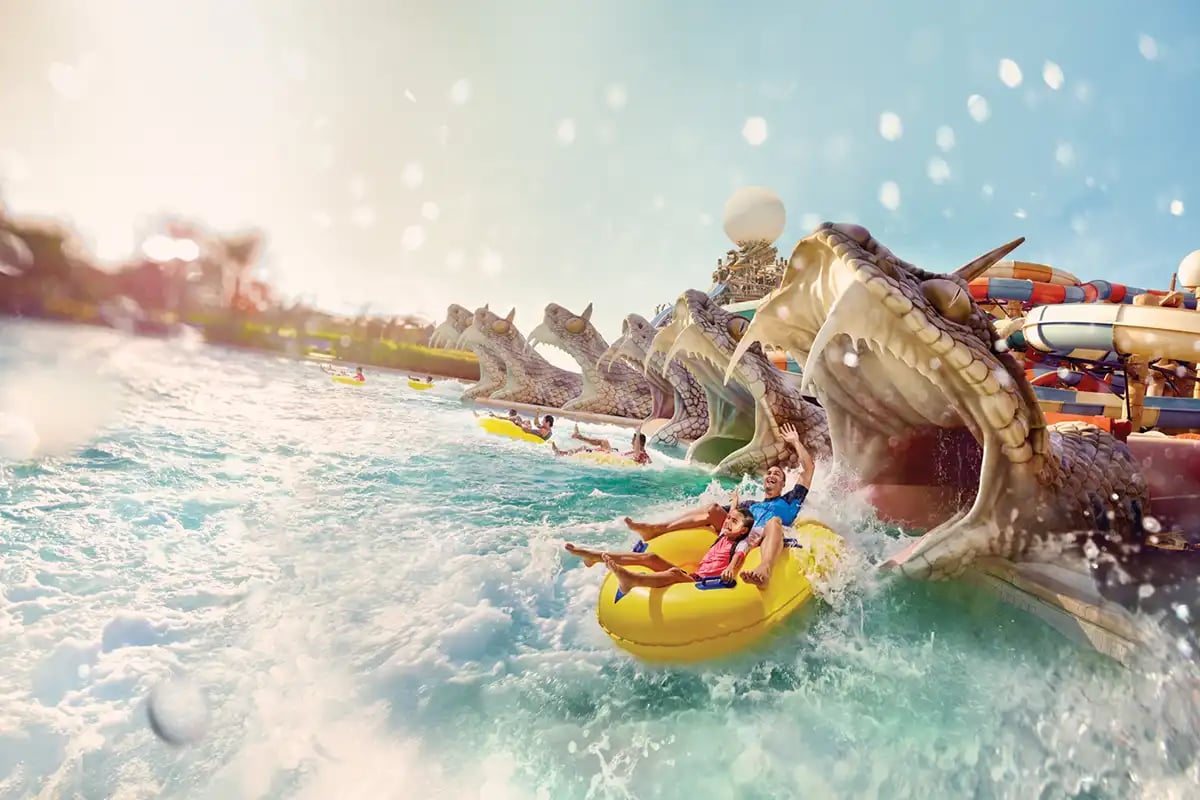 Family on a yellow tube ride at a water park.